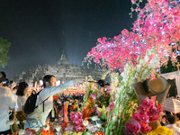 Devotees are bathing the statue of baby Siddhartha Gautama during the Vesak celebration. This ritual is signifying purification and the birt...