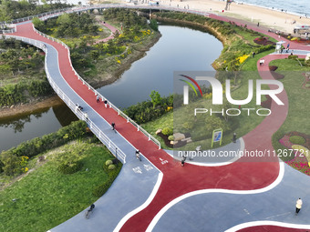 Tourists and citizens are enjoying themselves on the Sunshine Coast Greenway in Rizhao, China, on May 23, 2024. (