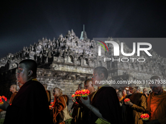 Buddhist monks are offering prayers at the celebration of Vesak Day 2568 B.E. at Borobudur Temple in Magelang, Central Java, on May 23, 2024...