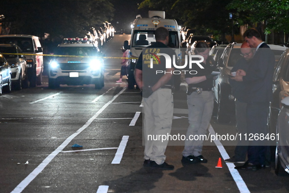 Police officers are gathering at the scene. Three people are being shot, and two people are dead in a shooting in Bronx, New York, United St...