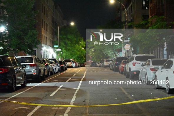 Police tape is blocking the area of the crime scene. Three people are being shot, with two people dead, in a shooting in Bronx, New York, Un...