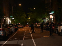 Police tape is blocking the area of the crime scene. Three people are being shot, with two people dead, in a shooting in Bronx, New York, Un...