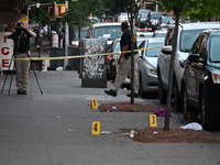 Evidence markers are at the crime scene as the crime scene unit is investigating the shooting. Three people are shot, and two people are dea...