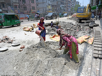 Women daily laborers work at a road construction site in Dhaka, Bangladesh, on May 24, 2024. (