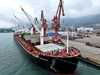 Cargo ships are parking at a berth to load wind power equipment for export at the terminal in Lianyungang, China, on May 25, 2024. (