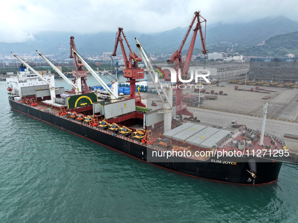 Cargo ships are parking at a berth to load wind power equipment for export at the terminal in Lianyungang, China, on May 25, 2024. 