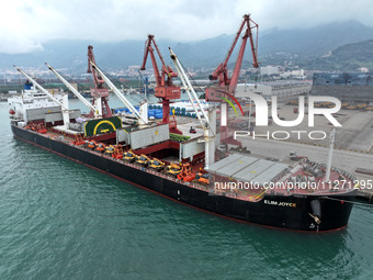 Cargo ships are parking at a berth to load wind power equipment for export at the terminal in Lianyungang, China, on May 25, 2024. (