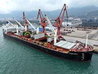 Cargo ships are parking at a berth to load wind power equipment for export at the terminal in Lianyungang, China, on May 25, 2024. (