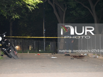 New York City Police Department officers are investigating the shooting scene. One person is killed and one person is injured in a shooting...