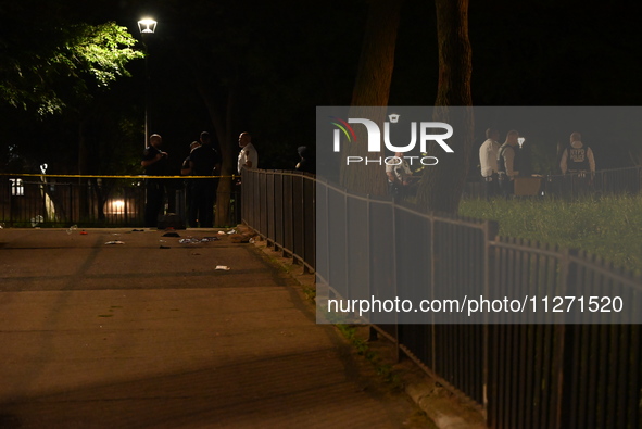 New York City Police Department officers are investigating the shooting scene. One person is killed and one person is injured in a shooting...