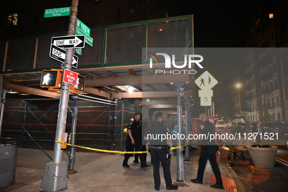 Police officers are investigating the shooting scene. A 27-year-old male is being shot in Manhattan, New York, United States, on May 24, 202...