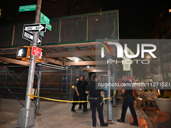 Police officers are investigating the shooting scene. A 27-year-old male is being shot in Manhattan, New York, United States, on May 24, 202...