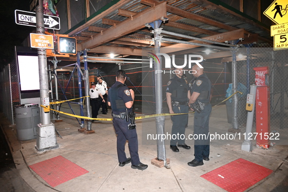 Police officers are investigating the shooting scene. A 27-year-old male is being shot in Manhattan, New York, United States, on May 24, 202...