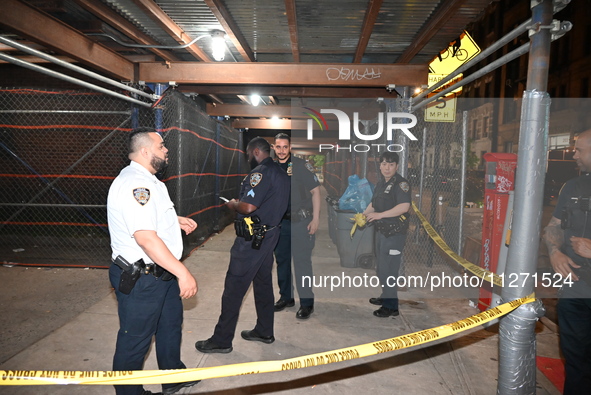 Police officers are investigating the shooting scene. A 27-year-old male is being shot in Manhattan, New York, United States, on May 24, 202...