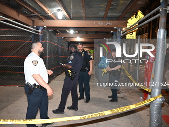 Police officers are investigating the shooting scene. A 27-year-old male is being shot in Manhattan, New York, United States, on May 24, 202...