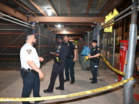 Police officers are investigating the shooting scene. A 27-year-old male is being shot in Manhattan, New York, United States, on May 24, 202...