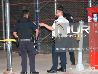 Police officers are investigating the shooting scene. A 27-year-old male is being shot in Manhattan, New York, United States, on May 24, 202...