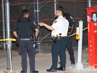 Police officers are investigating the shooting scene. A 27-year-old male is being shot in Manhattan, New York, United States, on May 24, 202...