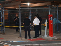 Police officers are investigating the shooting scene. A 27-year-old male is being shot in Manhattan, New York, United States, on May 24, 202...