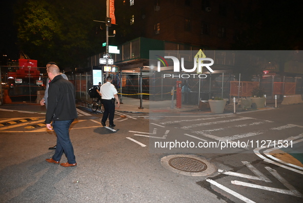 Police officers are investigating the shooting scene. A 27-year-old male is being shot in Manhattan, New York, United States, on May 24, 202...