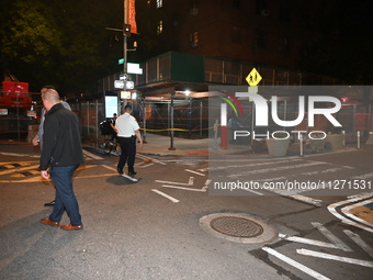 Police officers are investigating the shooting scene. A 27-year-old male is being shot in Manhattan, New York, United States, on May 24, 202...