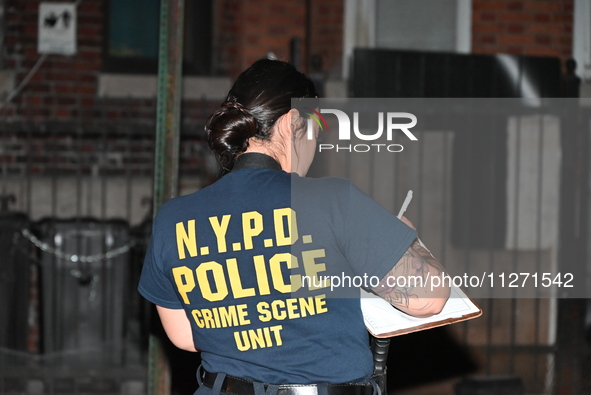 Crime scene investigators from the NYPD Crime Scene Unit are investigating the shooting death of 37-year-old Marcus Henderson, who was shot...