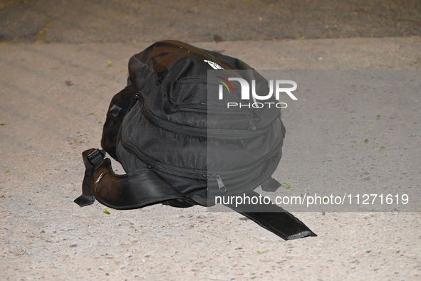 Crime scene investigators are marking shell casings and other evidence at the scene of a shooting where one person is killed and one person...