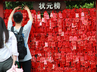 Parents are praying for a good score for their children who are taking the National college entrance examination (GAOKAO) at the Confucius T...