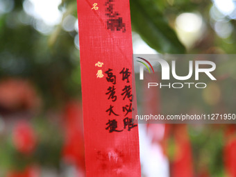 Parents are praying for a good score for their children who are taking the National college entrance examination (GAOKAO) at the Confucius T...