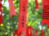 Parents are praying for a good score for their children who are taking the National college entrance examination (GAOKAO) at the Confucius T...