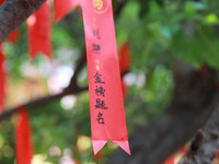 Parents are praying for a good score for their children who are taking the National college entrance examination (GAOKAO) at the Confucius T...