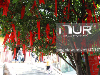 Parents are praying for a good score for their children who are taking the National college entrance examination (GAOKAO) at the Confucius T...