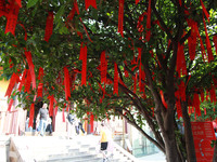 Parents are praying for a good score for their children who are taking the National college entrance examination (GAOKAO) at the Confucius T...