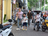 Citizens are walking on a street in Fuyang, Anhui province, China, on May 25, 2024. The World Health Organization (WHO) is releasing its ann...