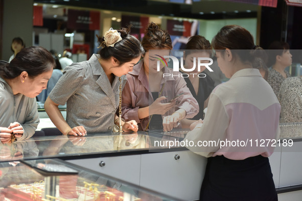 People are shopping for gold jewelry at a mall in Fuyang, China, on May 25, 2024. The World Health Organization (WHO) is releasing its annua...