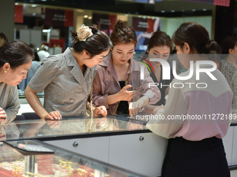 People are shopping for gold jewelry at a mall in Fuyang, China, on May 25, 2024. The World Health Organization (WHO) is releasing its annua...