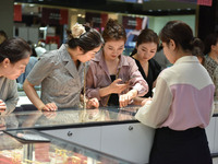 People are shopping for gold jewelry at a mall in Fuyang, China, on May 25, 2024. The World Health Organization (WHO) is releasing its annua...