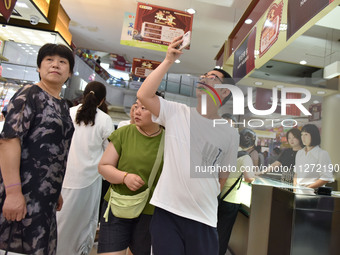 People are shopping at a mall in Fuyang, China, on May 25, 2024. The World Health Organization (WHO) is releasing its annual statistics on T...