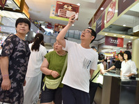 People are shopping at a mall in Fuyang, China, on May 25, 2024. The World Health Organization (WHO) is releasing its annual statistics on T...