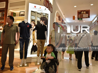 People are shopping at a mall in Fuyang, China, on May 25, 2024. The World Health Organization (WHO) is releasing its annual statistics on T...