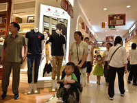 People are shopping at a mall in Fuyang, China, on May 25, 2024. The World Health Organization (WHO) is releasing its annual statistics on T...