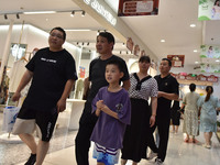 People are shopping at a mall in Fuyang, China, on May 25, 2024. The World Health Organization (WHO) is releasing its annual statistics on T...