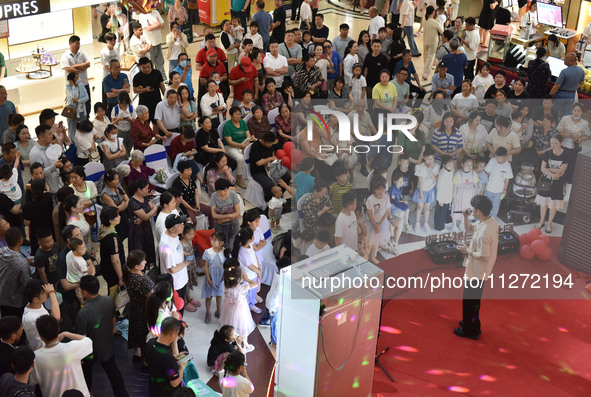 People are watching a performance at a shopping mall in Fuyang, China, on May 25, 2024. The World Health Organization (WHO) is releasing its...