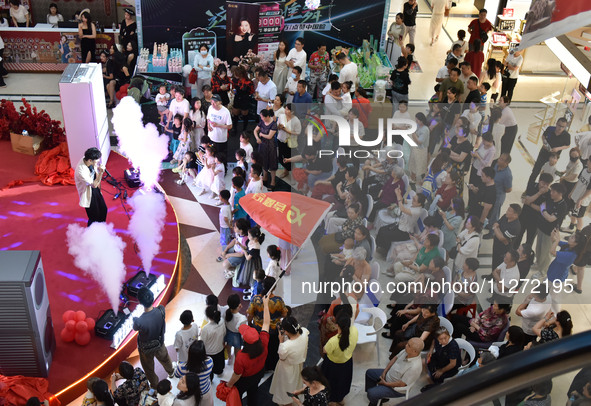 People are watching a performance at a shopping mall in Fuyang, China, on May 25, 2024. The World Health Organization (WHO) is releasing its...