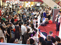 People are watching a performance at a shopping mall in Fuyang, China, on May 25, 2024. The World Health Organization (WHO) is releasing its...