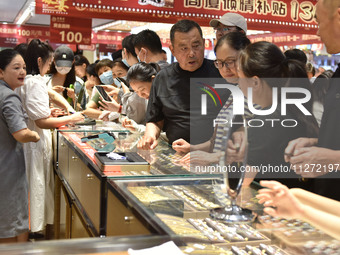 People are shopping for gold jewelry at a mall in Fuyang, China, on May 25, 2024. The World Health Organization (WHO) is releasing its annua...