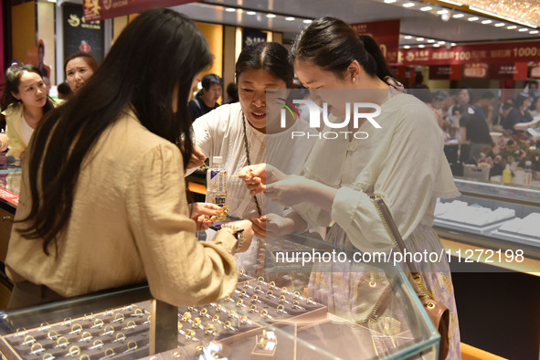 People are shopping for gold jewelry at a mall in Fuyang, China, on May 25, 2024. The World Health Organization (WHO) is releasing its annua...