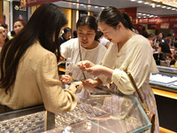 People are shopping for gold jewelry at a mall in Fuyang, China, on May 25, 2024. The World Health Organization (WHO) is releasing its annua...