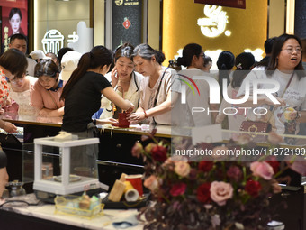 People are shopping for gold jewelry at a mall in Fuyang, China, on May 25, 2024. The World Health Organization (WHO) is releasing its annua...