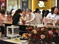 People are shopping for gold jewelry at a mall in Fuyang, China, on May 25, 2024. The World Health Organization (WHO) is releasing its annua...